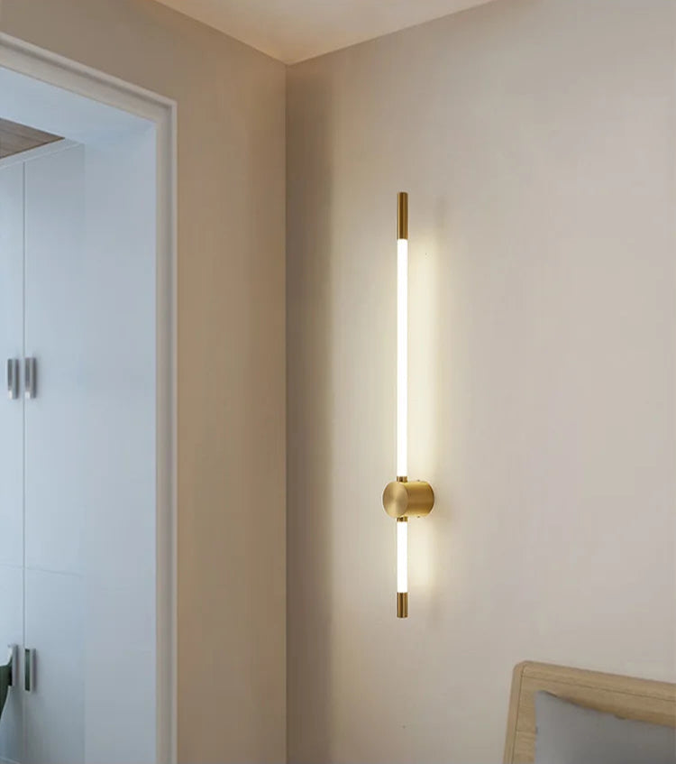Modern wall-mounted light fixture on a neutral wall.
