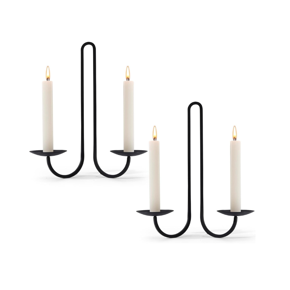 Black metal candle holder with four candles on a white background