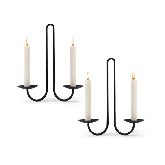 Black metal candle holder with four candles on a white background