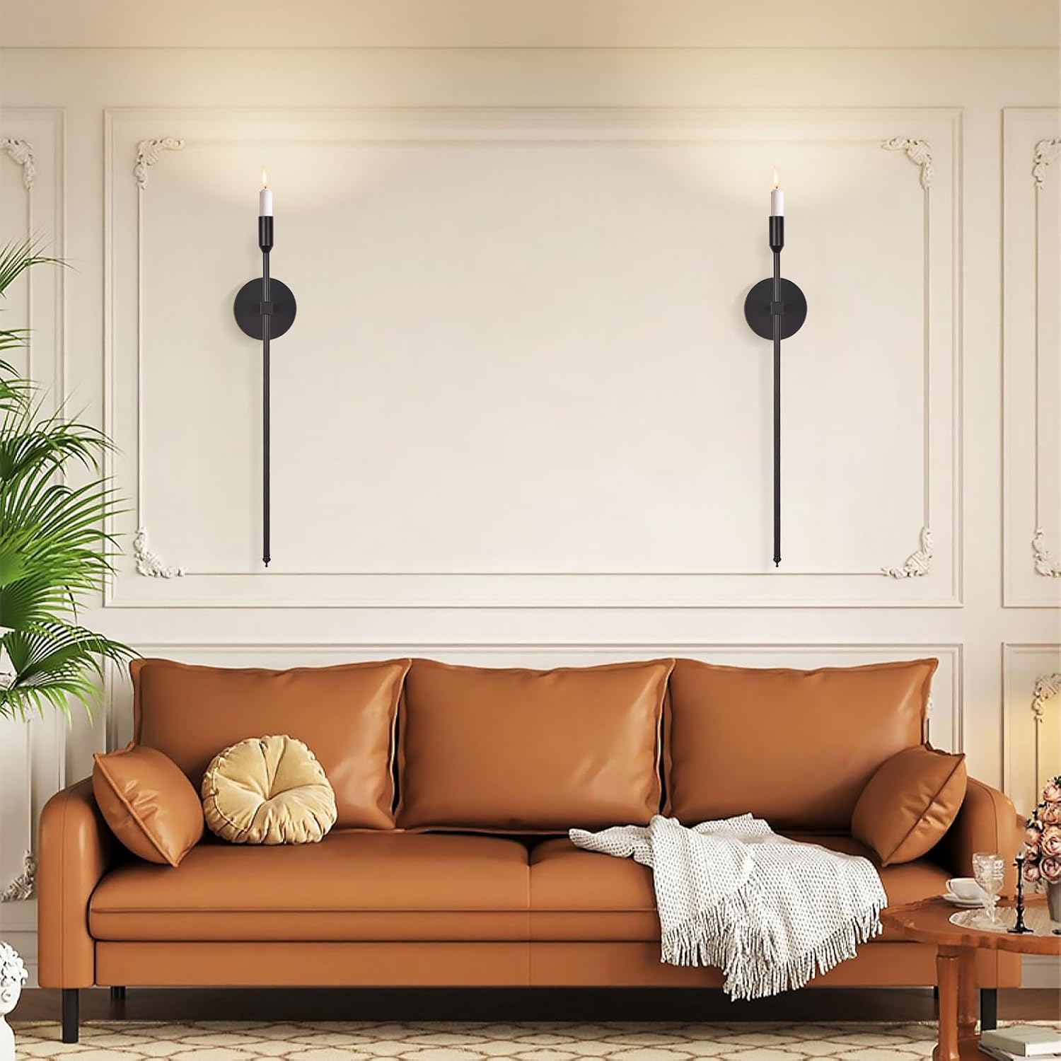 Brown leather sofa in a living room with decorative pillows and a plant.