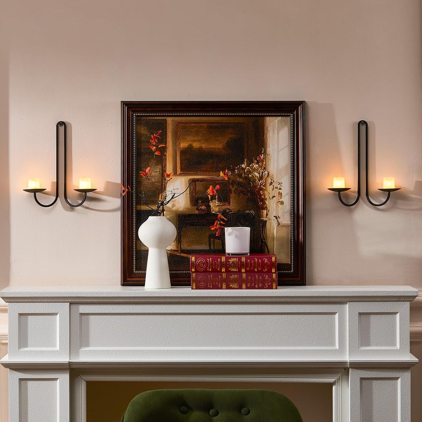 Decorative mantelpiece with a framed painting, books, and a vase on a beige wall.