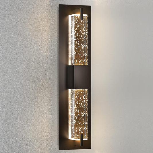 Decorative wall sconce with glass panels on a plain wall