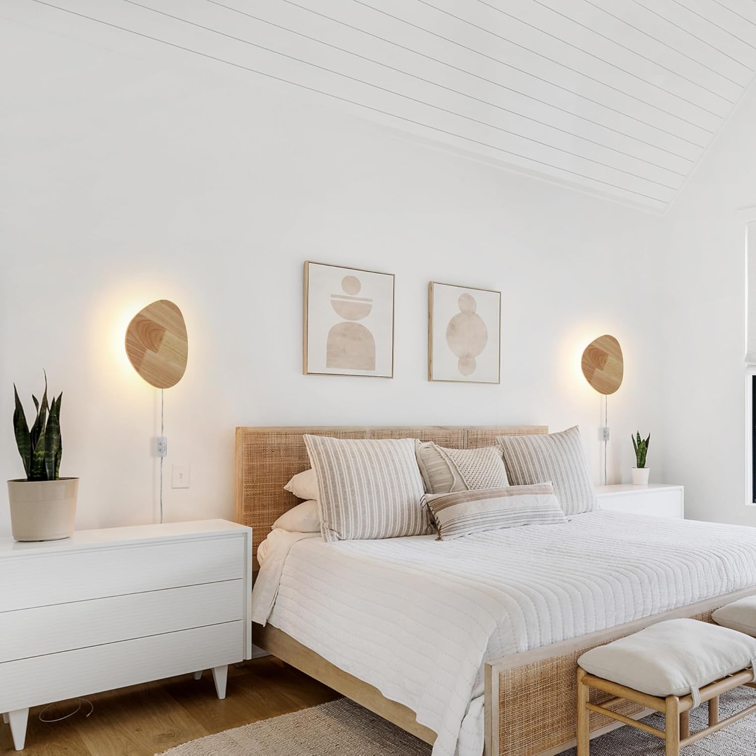 Modern bedroom with a bed, nightstands, and wall art.