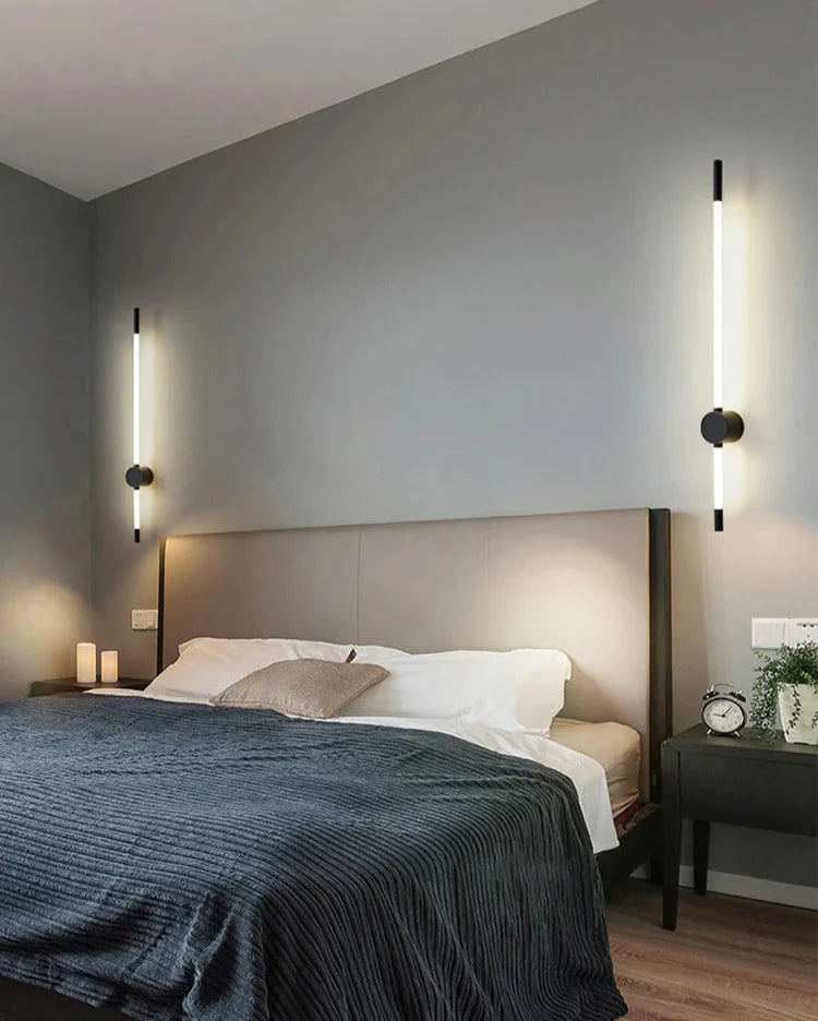 Modern bedroom with a bed, nightstands, and wall sconces.