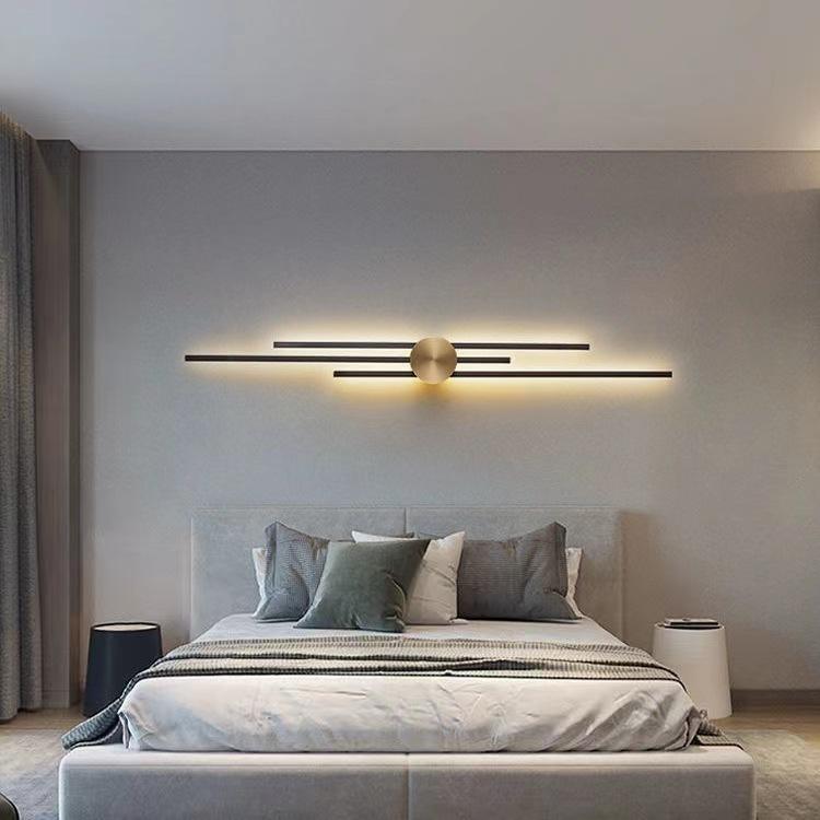 Modern bedroom with a stylish wall light fixture above a bed.