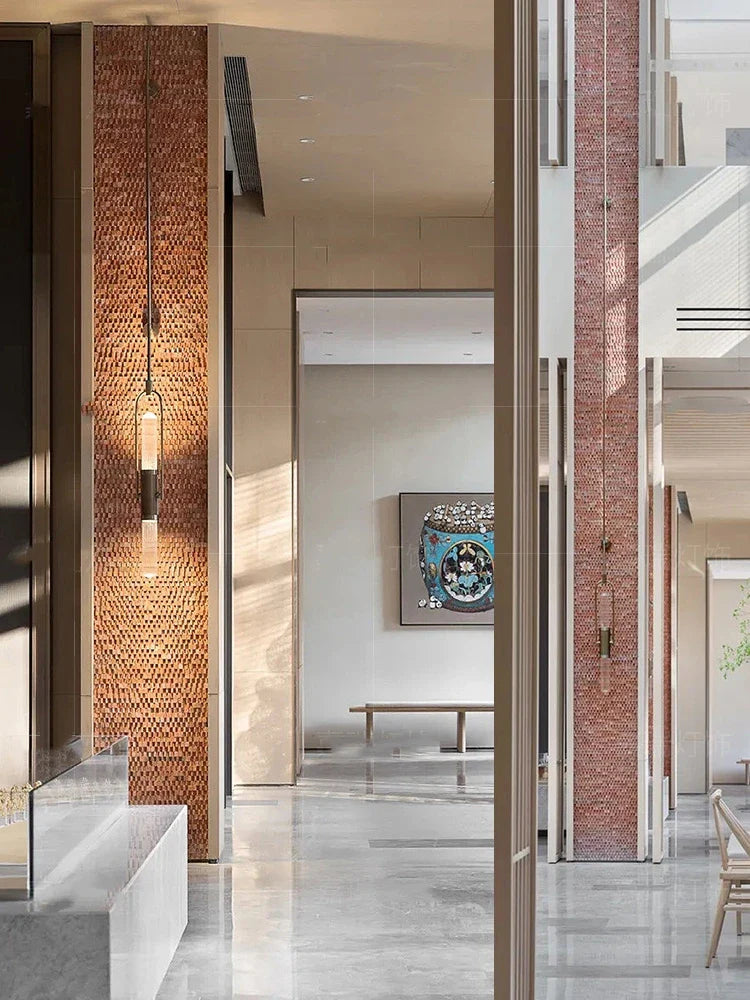Modern interior design with brick columns and abstract art on a wall.
