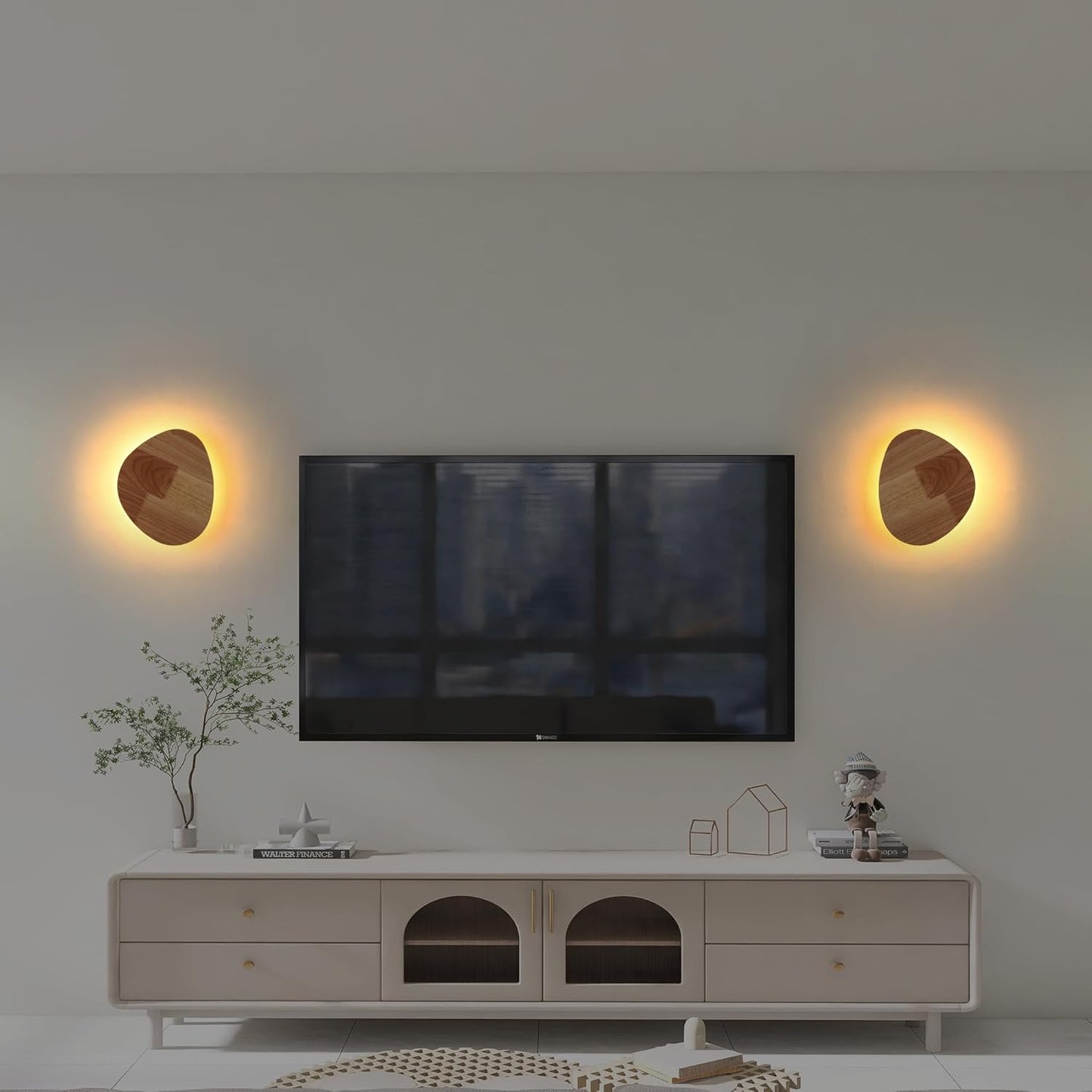 Modern living room with a TV mounted on the wall, flanked by two wall lights.