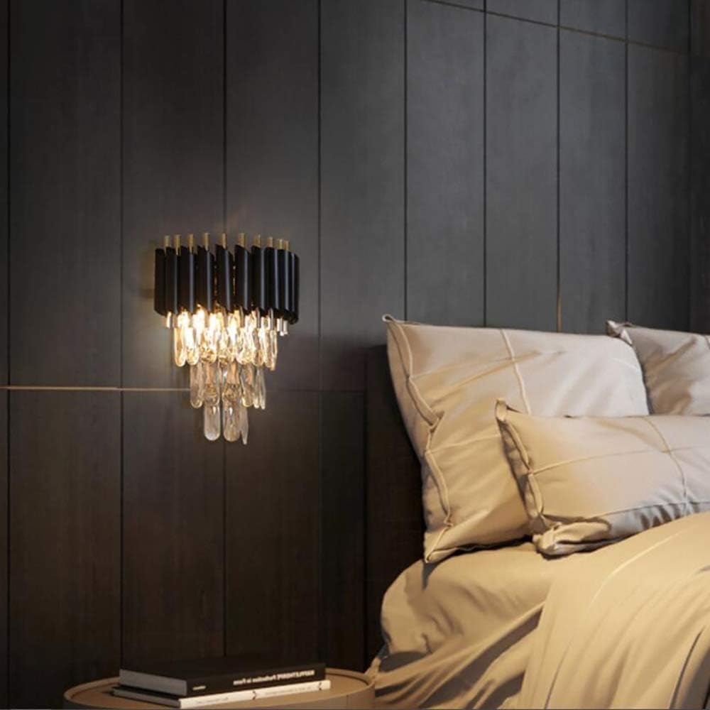 Modern wall-mounted lamp with crystal accents in a bedroom setting.