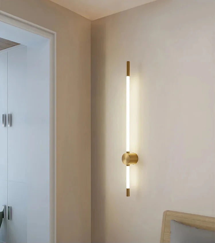 Modern wall-mounted light fixture on a neutral wall.