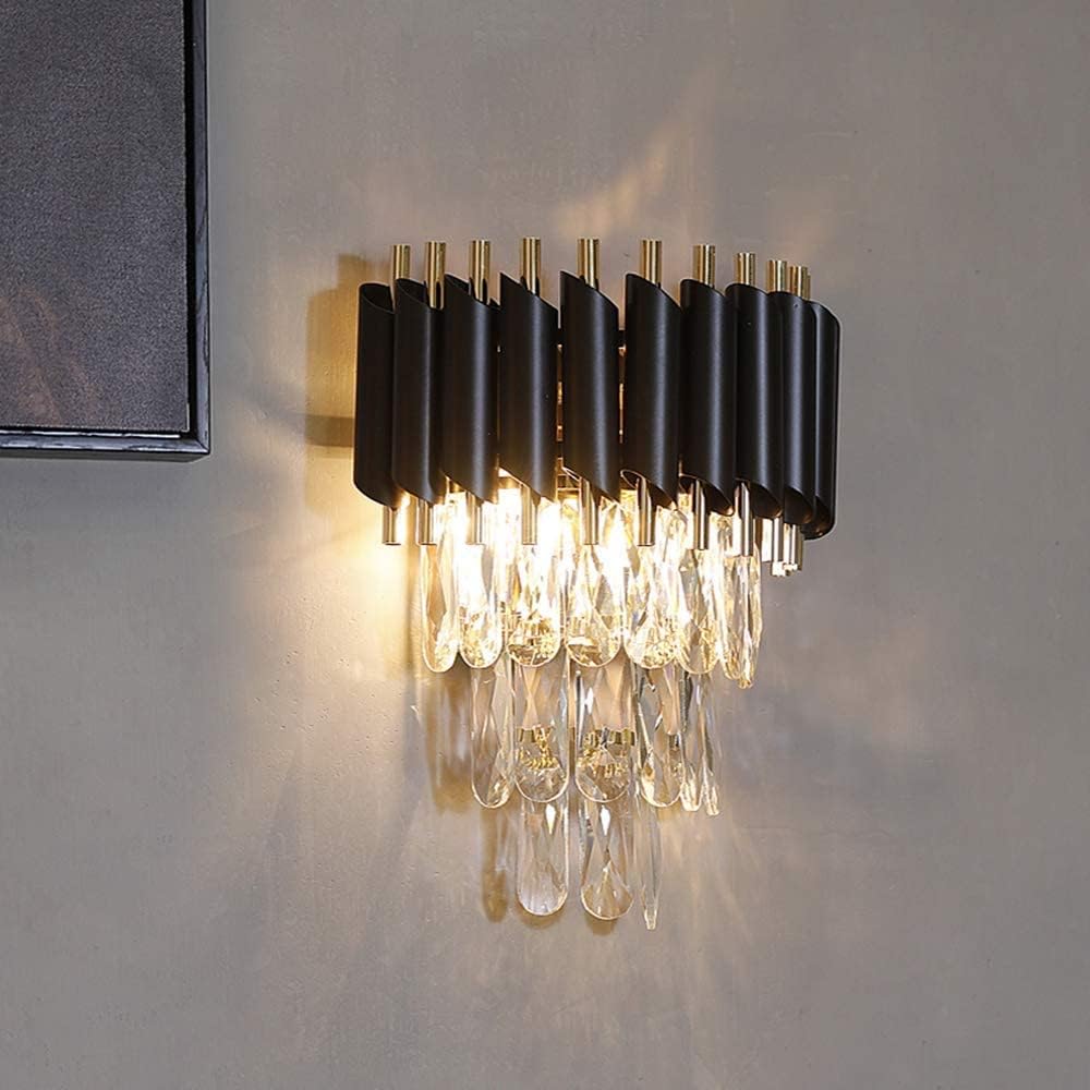 Modern wall-mounted light fixture with black and gold design on a gray wall.