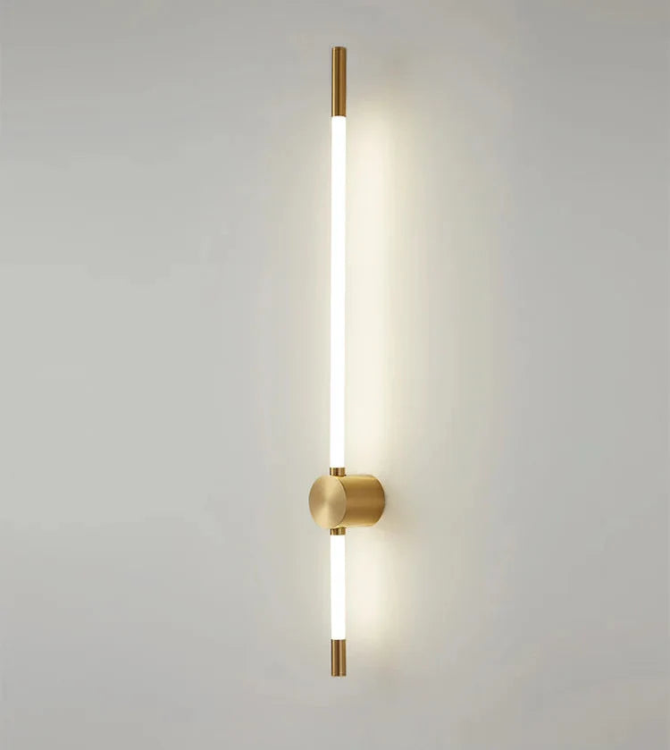 Modern wall lamp with gold finish on a light gray background