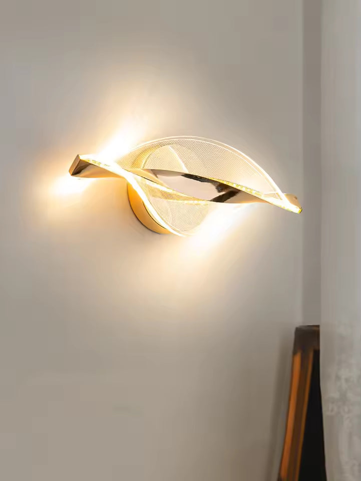 Modern wall sconce with leaf design on a neutral wall