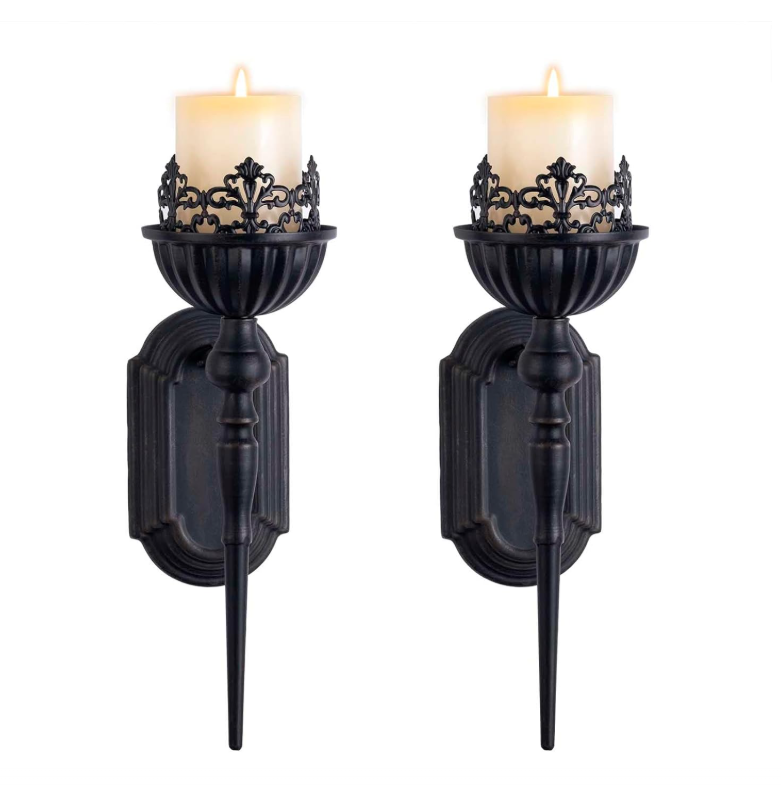 Pair of black wall sconces with candles on a white background