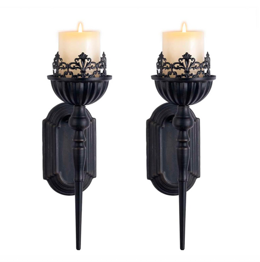 Pair of black wall sconces with candles on a white background