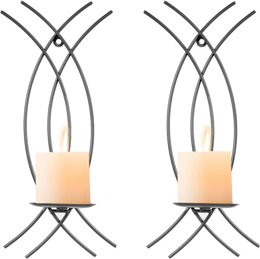 Two metal wall candle holders with candles on a white background
