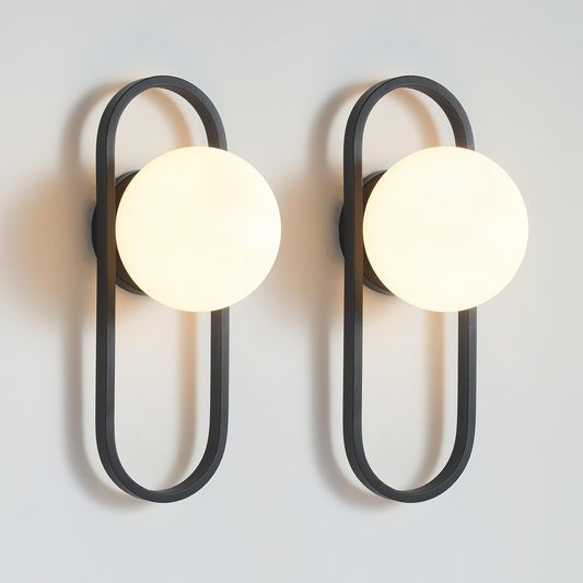 Two modern wall lights with black frames and white globe bulbs on a light gray background.