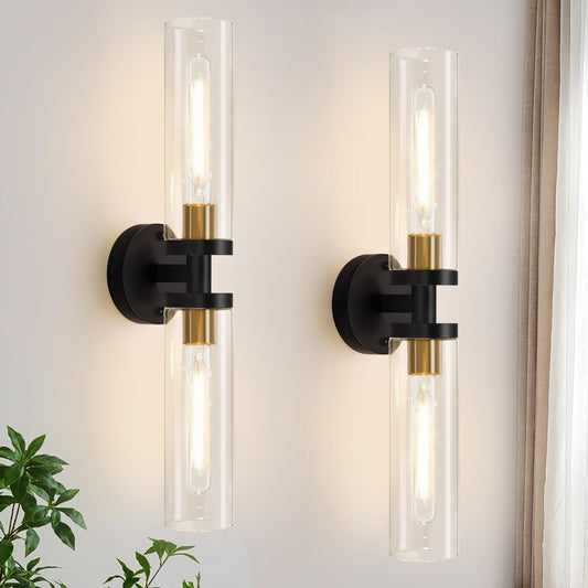 Two modern wall sconces with clear glass shades and black metal fixtures on a light gray wall.
