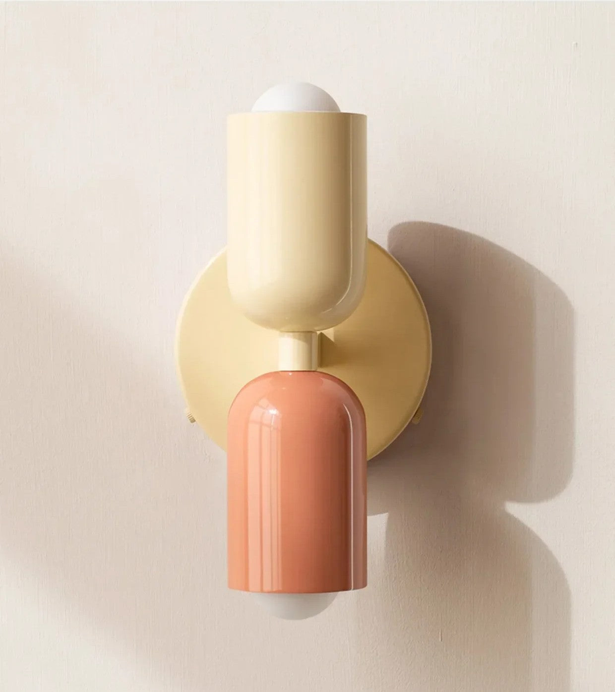 Wall sconce with beige and coral design on a light beige background